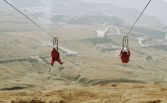 Four people on zip wires at